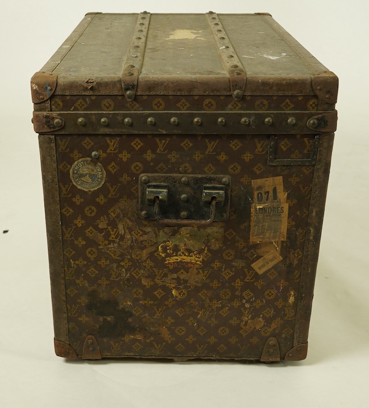 A vintage Louis Vuitton trunk, with black painted iron banding, wooden slats and canvas LV fabric, label for Paris, New Bond Street, Nice and Lille, numbered 776719, the interior with original tray, 76cm wide, 49cm deep,